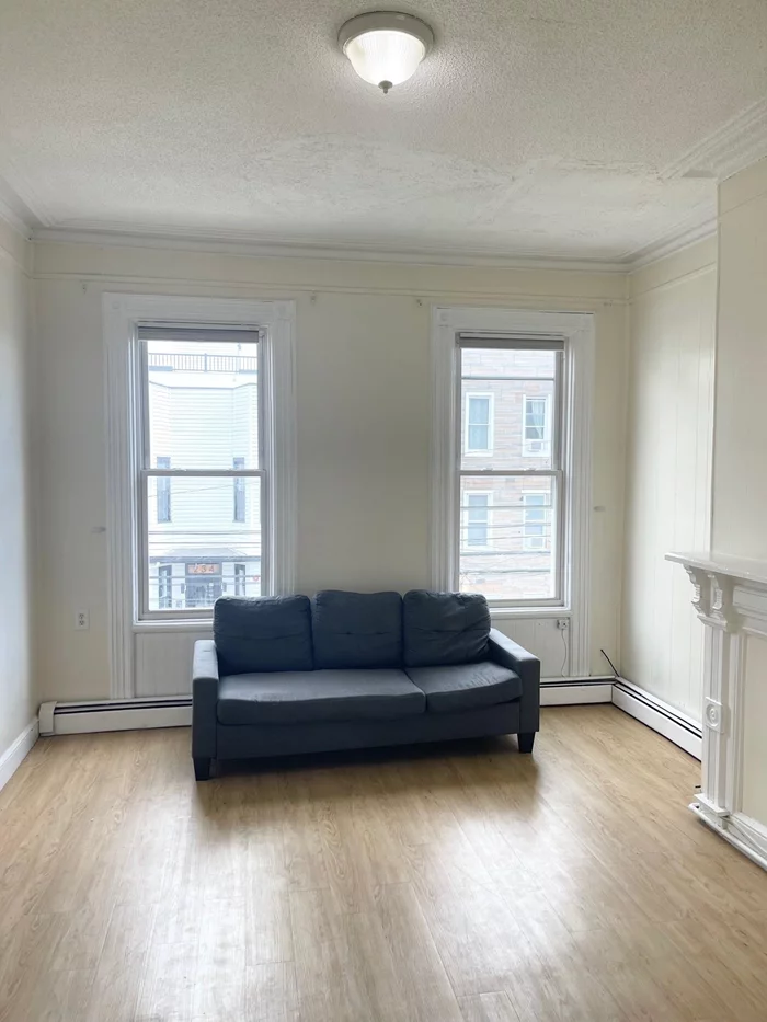 Welcome home to this bright and sunny, large 1 bedroom + 1 den apartment in the prime part of Jersey City Heights. The apartment boasts high ceilings, a spacious master bedroom, plenty of natural light.The apartment also has a little breakfast nook (a table with 2 stools). Refrigerator, stove and microwave are also provided. The apartment has its own thermostat. Option to rent a parking or just use the street parking. Public transportation is close by  Ninth Street / Congress Light Rail Station and a couple of minute to public & private bus route to the Hoboken Path & NYC. Lots of good restaurants near by, including amazing coffee shops , Farmer's Market and so much more. Call today for a private showing!