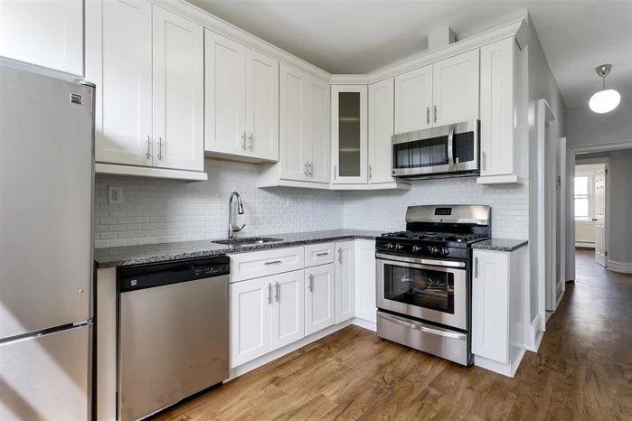 This gorgeous, contemporary 3 Bedroom apartment is located on a quiet street on the western slope of the Jersey City Heights. The home features a clean contemporary aesthetic with windows in every room that let in plenty of light no matter what time of day. The unit is fully renovated and well appointed with stainless appliances, hardwood floors, video intercom system and a washer/dryer in the building. The quality of the apartment can be seen in the high end finishes in the gorgeous kitchen and spa-like bathroom. There is plenty of storage throughout the space including a massive 3'x6' closet in the hallway and entire wall of closets in the 3rd bedroom. Laundry conveniently located in the building. Located just one block from Kennedy Blvd for easy access to the buses that run every few minutes to the Journal Square transportation hub.