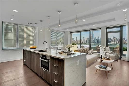 Discover the most premier and luxurious new construction building along the NJ Gold Coast. This beautiful 3 bedroom, 2 full baths, modern designed home has all the finest finishes & the most breathtaking DIRECT EAST views of NYC & Hudson River. YOUWILL NEVER GET A TERRACE THIS LARGE ON THE ENTIREWATERFRONT W/A GAS LINE FOR GRILLING & ENOUGHSPACE FOR THE WHOLE FAMILY-Grill included! Enjoy the world-class design and perfect floor plan stretching across 1510 sqft. Professional chef's kitchen featuring a large center island w/Aspen quartz countertops, Pedini cabinets, Bosch appliances, &Thermador fridge. Enjoy the wood flooring throughout, in-unit W/D, expansive closet space, ceiling fans in every room, towel warmers, 1(Opt2) garage car parking, & oversized windows w/custom automated shades & blackouts. The resort style amenities: 24-hrdoorman, state-of-the-art 2 level fitness center, amenity deck w/infinity pool & BBQ area, rooftop deck w/cabanas, shuttle to/from Ferry!