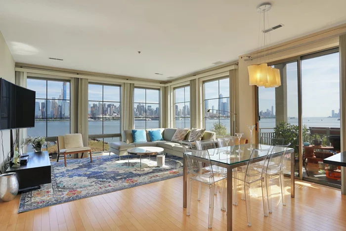 Enjoy this stunning South East facing home with NYC and the Hudson River views in this 2 bed 2 bath home located in the prestigious Hudson Club community. This 1, 222 sq ft, corner unit home, is flooded w/natural light all day long! Enjoy the hardwood floors throughout and a split bedroom layout w/Master en-suite, allowing for great privacy & great living spaces within the home. The open kitchen features SS appliances, granite countertops, & a breakfast bar. Enjoy the balcony above the tree-line overlooking to NYC and the River and the conveniences of an in home W/D. Rent includes water, hot water, gas, cable, internet, parking, & amenities. Hudson Club is fully accommodated w/luxury amenities including a fitness center, pool, basketball courts, tennis, playground, clubhouse & concierge with easy access to NYC commute. Located just steps away from NY Waterway Ferry and the NJ Transit Bus to Port Authority, ACME Grocery and Starbucks are right outside your door, don't miss this one!