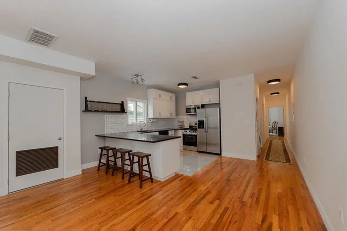 Located right in the center of Jersey City Heights, this oversiszed 2 bedroom should not be missed. Enter into a spacious living room with open layout to a generous kitchen with quartz countertops, stainless appliances and lots of natural light. This entire apartment has beautiful hardwood floors and 2 full baths. One bath is located in the primary bedroom along with a walk in closet and sliding door to a terrace. Laundry in unit and central a/c as well. Enjoy all this vibrant neighborhood has to offer with Riverview Park nearby, restaurants and bustling Central Ave. Bus transportation located nearby on Palisades with the 87 to Hoboken and the 119 to NYC. Available for immediate occupancy.