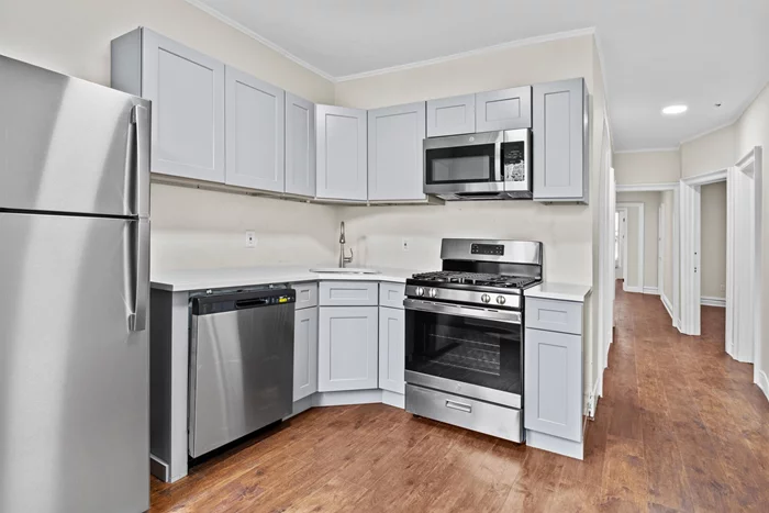 This beautifully renovated three-bedroom unit features stunning hardwood floors throughout and comes equipped with modern appliances, including a stainless steel stove, dishwasher, microwave, and refrigerator. Conveniently located close to transportation, the unit offers easy access to bus lines that connect to the Journal Square Path Train Station. Additionally, enjoy a shared backyard, perfect for outdoor relaxation and activities and one parking space for small car.