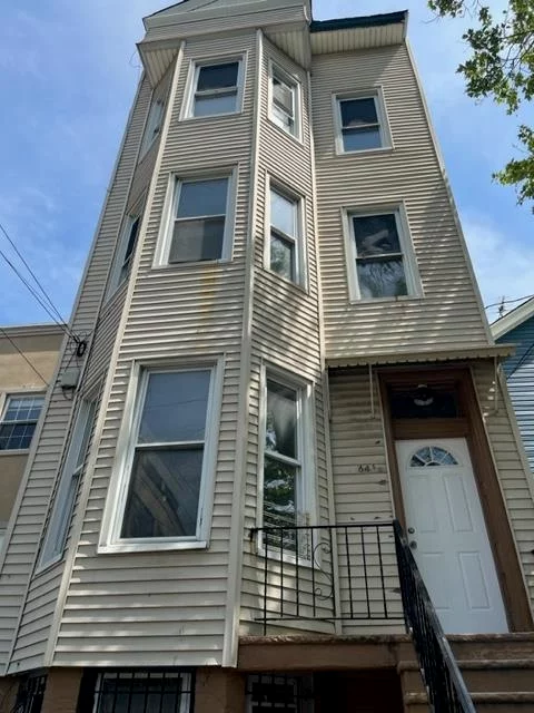 Step into this wonderfully renovated two bedroom which includes outdoor space (a backyard)! Hardwood grey washed wood floors, stone countertops, stainless steel appliances, separate dining area. Convenient to all transportation, parks, shopping, NYC bus stop 10 minute walk to Journal Square PATH station.