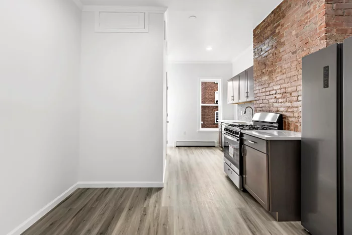 Right on the edge of Jersey City Journal Square, is a beautifully updated and bright 1 bed plus den, 1 bath railroad style unit. The kitchen has been updated with gleaming stainless steel appliances, an exposed brick wall complementing the new cabinets and granite counter tops. After a long day enter into a marble shower with a rainfall shower head to help wash the stress of the day away or unwind next to the electric fireplace with a nice book. This cozy unit has hardwood floors throughout and is the perfect escape from the busy city. You are just a short distance from the heart of Jersey City, located conveniently close to all major transportation, shopping, parks, schools, and the best eats Jersey City has to offer. Pets allowed with landlord's discretion, with a pet fee included.