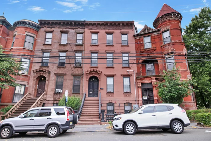 Discover this beautifully restored brownstone home nestled atop Bergen Hill in Jersey City. This stunning 3-bedroom, 3-bathroom meticulously crafted triplex home offers the perfect blend of historic charm and modern luxury. Step inside to the marble foyer and ascend upstairs to the main living area complete with original details like high ceilings, large windows, arched doorways, plaster ceiling moldings and beautiful hardwood floors. Enjoy open-concept living featuring a gourmet kitchen with quartz countertops and stainless steel appliances, a large dining area and living room with a marble mantle fireplace. The three spacious bedrooms have historic detail and decorative marble fireplaces. The ensuite primary bedroom is complete with large soaking tub as well as large shower. The spiral staircase on the top floor takes you to your private rooftop oasis, offering breathtaking views of the Manhattan skyline, Liberty State Park, and downtown Jersey City. This home is ideally located near parks, bus transportation, the Journal Square PATH and the vibrant community of Jersey City. Available immediately. Special incentives for October 1 lease.