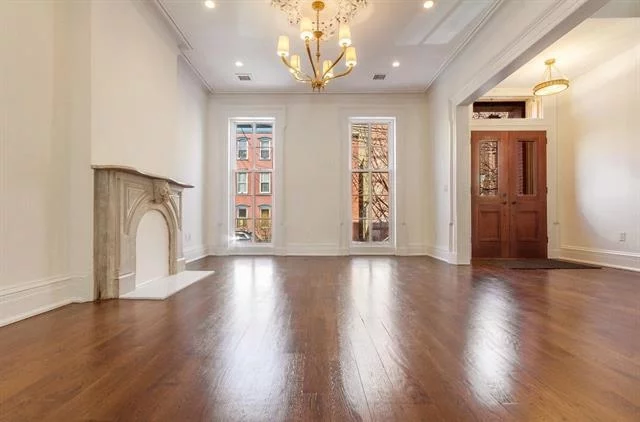 Welcome to this magnificent four floor residence just minutes from Van Vorst Park. This gorgeous brownstone blends modern amenities with timeless details throughout. Begin in the large living room, which has white oak HW floors and a decorative fireplace mantel. Continue through pocket doors to the dining room, which has brass light fixtures and preserved medallions. Nearby, the gourmet kitchen has quartz countertops, custom cabinetry, and top-of-the-line SS appliances. From here, enjoy access to a spacious rear deck, which leads to a stunning backyard. The 2nd level encompasses your primary area, featuring a floor-through suite with HW floors, 2 walk-in closets, and an en-suite with a marble vanity, heated floors, and glass-enclosed shower. This floor also features a private terrace and lounge area. The 3rd level has 2 en-suite bedrooms, each with large walk-in closets and luxury baths. The garden level features in-unit laundry, a multi-purpose room, and an additional bedroom. Magnificently located, you'll be just minutes from Van Vorst Park, the Grove St. PATH station, and countless trendy restaurants.