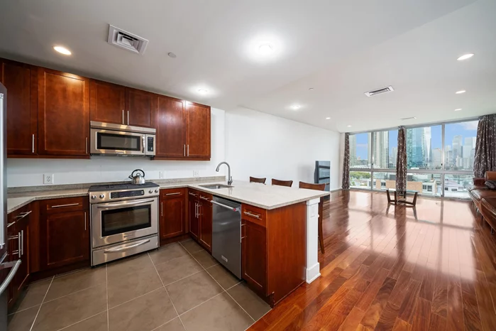 Stunning East facing 1000 sq. ft. 1 bedroom. Gorgeous views of JC & NYC. King sized bedroom with huge walk-in closet, gourmet kitchen with stainless steel KitchenAid appliances including gas range. Wood floors, C/A/C, W/D, floor-to-ceiling windows, and 9.5' ceilings. Garage parking available for an additional $200 per month. One small pet may be considered with a $50 monthly pet fee.