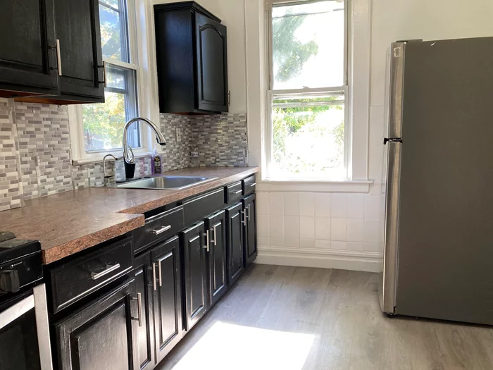 Sunny, renovated 2-bedroom apartment on quiet street. Parking for 2 cars. Laundry in basement. Freshly painted. Refinished hardwood and newlaminate floors. Open front porch. Large backyard. Stainless appliances.Available 12/1. Tenant responsible for first $100 of repairs.Tenant to submit NTN report and to have renters insurance.