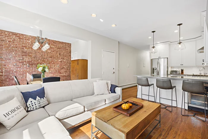 This downtown 2-bedroom condo features an open renovated kitchen with granite countertops and stainless steel appliances, a renovated bath with travertine tile, hardwood floors throughout, new light fixtures, and a washer/dryer in the unit. It showcases plenty of exposed brick and includes a dining alcove. The spacious bedrooms are set off the street. It's just a quick 7-minute walk to the Path. Fully furnished and available NOW through July 2025.