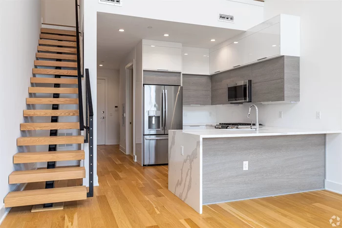 This 1 bed/loft/2 bath is meticulously designed with plenty of closet space. Organize with a large closet in addition to a linen closet close to the bathroom. The cabinets in the open kitchen maximize the storage space while incorporating a sleek modern look using two-tone cabinetry. The white lacquer uppers and lowers with textured grey mid cabinets along with the custom marbled Quartz countertops and its striking waterfall edge complements the natural oak hardwood floors. A full suite of GE Profile appliances is perfected with the installation of a fully vented range hood. Elegant cool continues in the bathroom creating a space that is both refined and functional with a floating white lacquer vanity and LED lit floating mirror. Baths are clad in large-format porcelain tile and feature luxe finishes and fixtures. A full-size Whirlpool washer and gas dryer are also in every unit.Amenities for residents: a private garage with assigned parking, a gorgeous lobby, a spacious and inviting exercise room and a comfortable common lounge. Just a key turn away, your future home is ready for move-in!