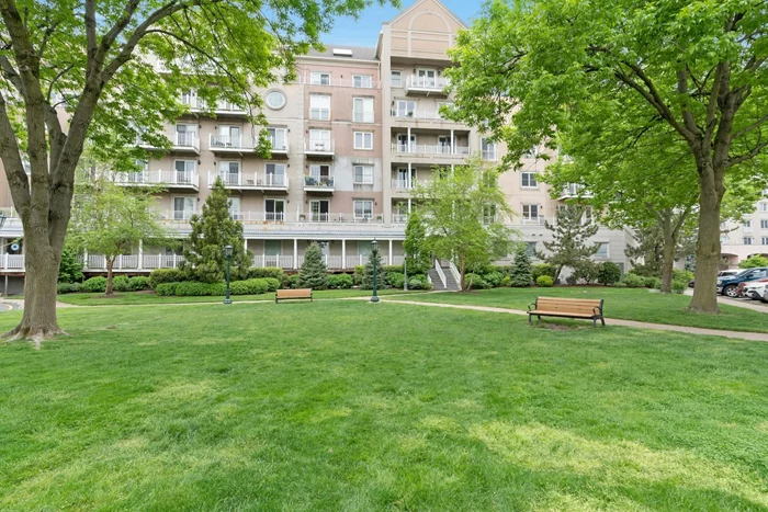 Overlooking sylvan Shearwater Court East this home offers year-round park-like views and seasonal partial views of the Hudson. This 1460 sf 2 bedroom, 2 baths all-on -one-level with oversized balcony offers included garage parking.  The spacious, entertainment sized open concept Great Room boasts plenty of windows for a light and airy ambience, wood floors throughout, and more than ample space for your full living and dining sets. Generous sized balcony is perfect for an after-work glass of your favorite chardonnay as you enjoy the sunset glow or morning sunrise with your coffee as you ease into the day. The bright and spacious kitchen offers expansive workspace, generous cabinet space, custom backsplash, newer stainless-steel appliances and even a peninsula breakfast bar with additional storage.  The principal bedroom suite is spacious and will easily accommodate your king-sized furniture with space left over for a cozy reading nook or home workspace and offers generous closets. Large, bright full bath with luxury shower. Generous second bedroom with more than ample closet space and stylish second bath with tub/shower.  Other features of this home are storage throughout, washer and dryer in the unit, central air conditioning, included garage parking and Port Libert amenities including peace of mind 24-hour gatehouse security, professional style fitness facility, two outdoor pools, tennis courts, basketball court, outdoor play area, fenced dog run, designated green spaces, free guest parking and idyllic waterfront promenades. Onsite also in the fitness facility, at additional charge, are personal trainers and massage therapy. In the commercial area are professional offices, Liberty Montessori: The Place for Learning preschool and daycare and fine dining restaurant Felina Steak at the renowned Hudson House. Easy commute to NYC via onsite high-speed ferry or Weekday Shuttle to Grove St PATH. Just seconds to major highways, Holland Tunnel and mere minutes to Newark Liberty Airport. Rent includes heat, water, hot water, garage parking and use of Port Libert amenities.