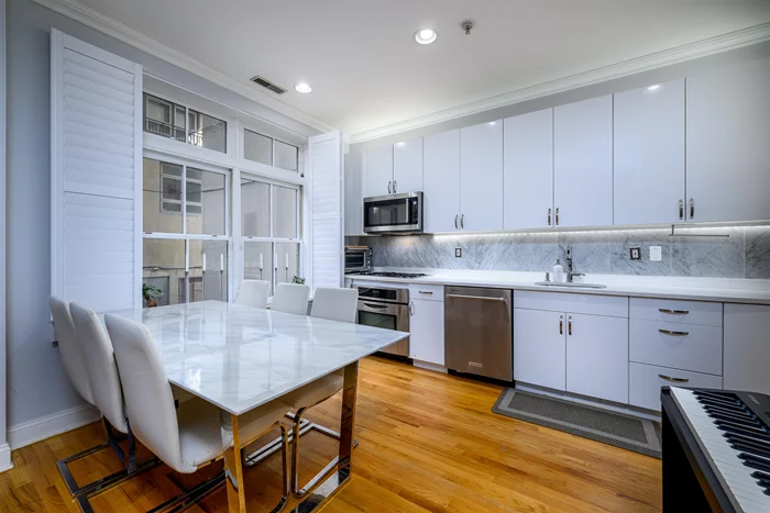 This modern luxury Paulus Hook duplex condo has high ceilings, renovated kitchen with quartz countertop and KitchenAid appliances, gut renovated bathrooms with rainfall shower heads, and floor-to-ceiling porcelain tile with marble floors, full size in-unit washer & vented dryer, tankless water heater for on-demand hot water, central air conditioning with UV sanitizer, sound insulated walls, ButterflyMX intercom. The unit features a private 800 square foot finished courtyard and patio, which is for the exclusive use of the unit's tenants, and can be accessed from either level. The apartment is located near the Exchange Place PATH Station and recently opened Whole Foods Market; as well as the Grove Street PATH and Paulus Hook Ferry to New York City.