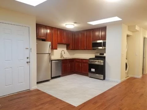 EASY TO SHOW. Beautiful 3 BR in Downtown Bayonne. Freshly painted. The unit features high ceilings, hardwood floors central air and heat, open layout living Room and renovated modern kitchen with stainless steel appliances. Great size bedrooms, in unit washer/ dryer, large backyard. Requirements: One-and-a-half-month security deposit, credit check by NTN, employment check. Prospective tenants must have combined gross income of 3 times rent. Tenant pays ALL utilities including a share of water/sewer cost. No Pets. One of the owners is a licensed real estate agent Very accessible location- a few blocks to 8th street Light Rail station, close to transportation, schools, restaurants and shopping.