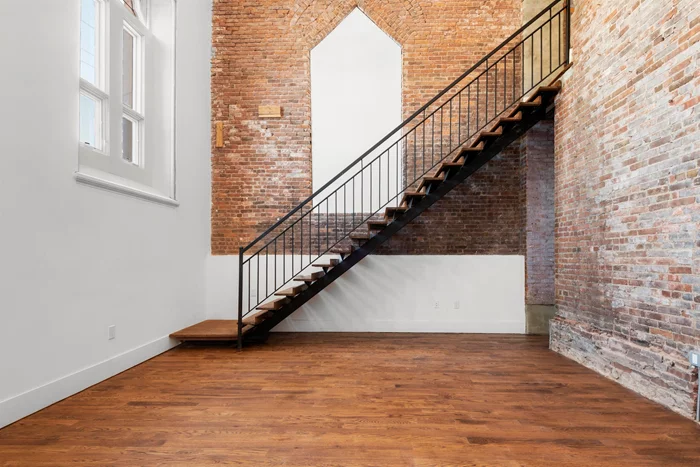 This unique one bedroom duplex at The Bridget, a one-of-a-kind, adaptive reuse 44-unit luxury residential project of a stunning historic landmark nestled in the heart of downtown Jersey City features original brick walls & stained-glass windows, a grand staircase to the 2nd level, 5 oak plank flooring, over 20' ceilings in the living room, central HVAC, in-unit washer/dryer, and a classically monochromatic color palette that enhances the uniqueness of their revered historic features. This exceptional unit invokes the spirit of the site's previous life as St. Bridget's church. - - - Original building elements such as the slate roof, stained-glass windows and other architecturally significant aspects are restored and enhanced, the ideal complement to the contemporary, refined design within. - - - Custom matte white cabinets are accented by penny tile backsplash and polished Caesarstone countertops. Stainless steel appliances including a sink with a matte black Rigo faucet, refrigerator, dishwasher, gas range and hood complete these well composed kitchens. - - - Select amenities include bike storage, an indoor lounge area, also ideally suited as a co-working space as well as a fully equipped state-of-the-art fitness center. - - - Well situated in a cozy pocket of Historic downtown Jersey City, this appealing neighborhood, blocks away from the Hudson River waterfront, restaurants, museums, nightlife, great shopping, and parks which includes Liberty State Park, the Hudson River's crown jewel, and Van Vorst Park an historic gem utilized by an active community for farmers markets and a myriad of events. - - - Efficient access to Manhattan and elsewhere is close by at the Grove Street PATH stop, another enticing spot with pedestrian-only walkways, restaurants, and shopping options. - - - Pets are considered on a case-by-case basis!