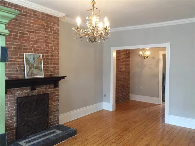 830 sq ft. Tons of old world charm, two separate bedrooms, 1 large, 1 small fireplace, original Pinewood flooring, plantation shutters, ss appliances, mantel, armoire, kitchen island, pot rack in charming historic building. Free laundry and storage in basement. Heat, HW included.