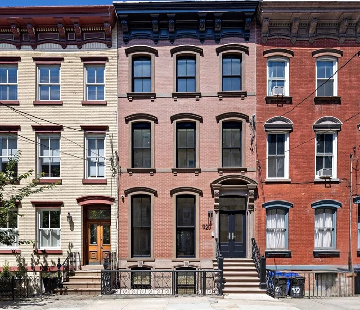 Presenting 920 Park Ave, a stunning 5-bedroom, 4.5-bathroom brownstone townhome on a 20'x100' lot. This luxury residence combines modern design with impeccable craftsmanship, featuring solid white oak chevron hardwood on the parlor floor, 6 straight plank hardwood upstairs, and 24x48 porcelain tile on the garden level. The Chef's kitchen boasts white oak cabinetry, Calacatta Viola marble countertops, a Subzero 48 fridge, Wolf dual fuel range, and custom hood. The master suite offers an opulent en-suite bathroom, dual walk-in closets, and Brizo luxe gold fixtures. Additional bedrooms include walk-in closets, plus a dedicated home office. Smart home features include EcoBee thermostats, ultra-efficient HVAC systems, and tankless water heaters. The laundry room is equipped with Electrolux front-load steam washer and dryer and a Caesarstone countertop. 920 Park Ave offers an unmatched blend of luxury, sophistication, and modern amenities, creating a truly exceptional living experience.