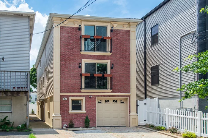 Discover modern comfort in this newly renovated, multi-level townhome located in the heart of Jersey City Heights. Perfectly tailored for working professionals this stylish residence offers an ideal blend of space, functionality, and contemporary living.The first floor welcomes you with a versatile open space, complete with a wet bar and full bath perfect as a home office, guest suite, or creative studio. Ascend to the main level, where a gourmet kitchen awaits, featuring brand-new stainless-steel appliances, a movable oversized island, and a seamless flow into the dining and living areas. A powder room and laundry closet add convenience to your busy lifestyle.Retreat to the top floor, where two generously sized bedrooms provide a serene escape. The primary bedroom features a charming Juliet balcony, creating the perfect spot to unwind after a long day. Ample closet space and a beautifully appointed full bathroom complete this level.Step outside to your private backyard oasis, ideal for summer evenings, or take advantage of the convenience of your own carport parking space. Situated near major transit options, shopping, parks, and schools, this home is perfect for commuters or anyone seeking the vibrancy of city living.Don't miss the chance to call this exceptional townhome your own!