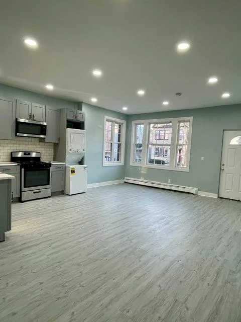 Don't miss out on this AMAZING, rare opportunity to rent a gorgeous, fully renovated 4-bedroom apartment in the heart of Jersey City! This spacious unit features 2 full bathrooms, a private backyard perfect for outdoor relaxation, and a garage that fits 2 cars  an absolute luxury in this vibrant area! Plus, you'll enjoy the convenience of an in-unit washer and dryer. Located just minutes from Journal Square Path Train Station, St. Peter's University, and Downtown Jersey City, this apartment places you at the center of it all. With trendy dining, shopping, and entertainment options right at your doorstep, you'll have everything you need to live in style. And yes  it's PET FRIENDLY! So, bring your furry friends along to enjoy your new home. This opportunity won't last long, so don't wait! Call now to schedule your appointment and make this incredible apartment your next home!