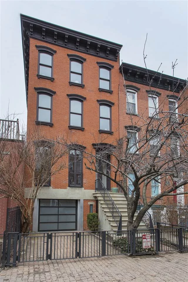 Rare opportunity to own this 20-foot-wide turn-of-the-century four-story townhome in midtown Hoboken with parking for 2 cars including a private garage. This expansive historic home offers approximately 3300 SF of living space over 4 levels with 4/5 bedrooms, 3.5 bathrooms and a lush 680 SF private backyard garden as well as a 300 SF green roof garden. Windows on 3 sides of the top 2 levels drench the upper part of the home with southern sunlight and provide open views over Hoboken's rooftops. Modern design details are combined with original details that include plaster moldings, an original curved staircase/handrail, two working fireplaces and original wide plank pine floors. Completely renovated in 2006 and extended in 2011, every inch of this home has been updated and improved with all new plumbing, electrical, insulation, roof, 4-zone central AC, 2-zone hydronic heat, Marvin & custom windows, as well as a new kitchen, baths and a handsome restored brick faade. The open chef's kitchen with painted white and walnut custom cabinetry, slate countertops, a Viking gas range, Miele dishwasher a Sub-Zero refrigerator & a wet bar with a Sub-Zero wine fridge. Conveniently located in midtown Hoboken only a short distance to the Hoboken PATH/Train/Ferry Terminal for easy access to New York City & is in the heart of everything that Hoboken has to offer including restaurants, parks & boutique shopping.