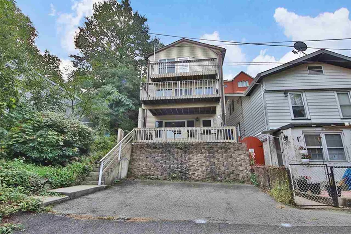 If you were told there was a spacious single home, a perfect hideaway that offered NYC views from a private cul de sac that gave you privacy with peaceful surroundings and was reasonably priced you probably wouldn't believe it. Presenting 9048 Wall St located in the Shadyside of North Bergen and standing above River Road, this lovely 3 Br 3 1/2 custom built home gives you a complete in-law suite or home office option with three levels, three terraces that invite picturesque river views, shore ike breezes, and all from a hillside and only 10 minutes from NYC. Highlights include a wood burning fire place, hardwood floors, open floor plan, tons of natural sunlight, 2 car parking, 3 zone HVAC, reasonable taxes and an ideal location giving you convenient access to your awaited new life's routine. Anyone who appreciates a mix of city and suburbia will love this home. A must see!