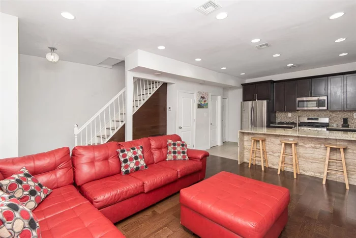 Don't miss this amazing tri-level one-family unit in the bustling Jersey City Heights! This 2BR+Den/2.5BA home is wonderfully updated. The kitchen boasts beautiful espresso wood cabinets, tile backsplash, stainless steel appliances and a standout countertop/breakfast bar. Well-kept hardwood floors throughout, recessed lighting and central AC. Also includes bonus rec room, full bathroom & storage in the finished basement. Plus 2 private, off-street parking spaces. Close to shops, restaurants, schools, transportation (buses to NYC, JSQ PATH, & Hoboken PATH just 1 block in either direction) & only minutes to the Holland Tunnel.