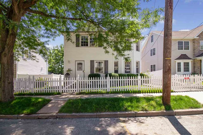 Welcome home to this picturesque side hall colonial located on a gorgeous tree lined street. Walk through your picket fence and enter into this 3 bed 1.5 bath home. Entry foyer w/ timeless black and white checkered floors and a perfectly placed powder room. Living room features custom molding all centered around your decorative fireplace. Renovated eat in kitchen with stainless steel appliances & plenty of cabinets for storage. Slide out to your large yard perfect for entertaining with a two tiered deck and manicured lawn. Head upstairs and you will find 3 bedrooms and 1 full bathroom. Partially finished basement with laundry room. Oversized driveway with room for 3 cars. Conveniently located close to Train station, NJ Transit bus, downtown shops and restaurants and major highways. Come see what makes Rutherford so desirable.