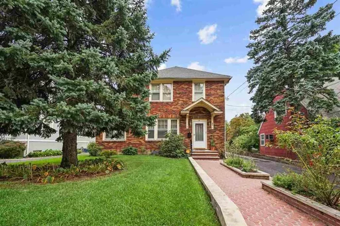 Sunny and spacious all brick 4 bedroom/2.5 bath Colonial with timeless charm and character. Step inside this 1764sqft home (excluding full finished basement and attic) and be impressed by all the possibilities and details; gleaming, original Pitch Pine floors throughout, entry foyer with closet and glass door to shield the elements, sunroom, and open living and dining areas with french doors separating den with full bath. Alcove kitchen opens up to the backyard and steps to the basement. Second floor boasts 3 generous bedrooms with ample closet space, one full bath and access to a finished attic with window ...perfect for an additional bedroom! The lower level has a bedroom, living room and an additional room currently used as a recreation room. A full bath and laundry room complete the space. Additional features include: new roof with energy efficient Solar panels, detached 2 car parking with side parking for guests. Sun house with apple and cherry trees, and vegetable garden in the backyard.