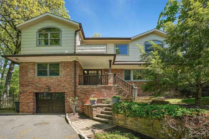 Framed by mature trees and lush landscaping, this classic Contemporary makes a wonderful first impression. Cast a critical eye at the wondrous hand-finished hardwood floors, lovely woodworking, handrails and posts, and appreciate the perfectly planned flow of the living level affording the finest surroundings for gala entertaining and fabulous day-to-day living. The banquet-sized Formal Dining Room opens to a Family Room/Den/ Office overlooking the walk out patio and verdant rear lawn. The gourmet chef's kitchen boasts 2 toned custom Kemper cabinetry outfitted with signature SS appliances, granite and Jerusalem limestone countertops, custom full backsplashes and a center island for showcasing your culinary feats. An adjoining breakfast room is just right for casual dining, arts and crafts, or game night. Curl up with a good book in the Great Room, and bask in the glow of the flickering wood burning fireplace. Stroll into the Solarium with its soaring ceiling, Velux skylights and stroll the bluestone patio-enjoy the serene beauty of the manicured yard. Vaulted ceilings and exposed beams grace the sleep level, with its massive Master Bedroom, sitting area, walk-in closet and lavish spa bath, appreciate the spaciousness of the guest bedrooms and decorated bath with a jetted tub and custom vanity and fixtures. Visit the lower level and its oversized guest suite, or au pair accommodations, with a king-sized bedroom/sitting room, home office,  designer bath with steam shower and copious closets, plus full laundry room. Completely refurbished and refitted-from new electrical and plumbing systems, Cat wiring, cable and custom sound experience with speakers throughout, Marvin Doors and windows, hardwired security and safety by ADT, bluestone and paver steps and walkways, front and rear lawn sprinkler system, exterior patio speakers, fenced yard and a new storage garden and potting shed, with an extra large attached garage, there's nothing for you to do but Move In! Don't put your dreams on hold-make them come true by owning this outstanding, simply superlative and aesthetically elegant home.