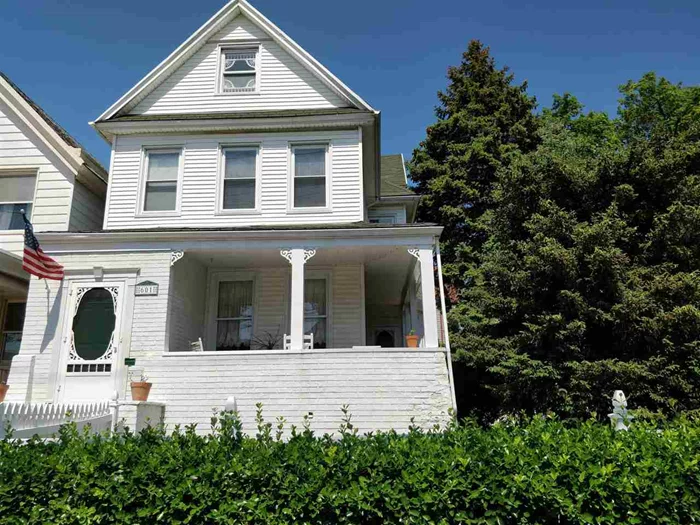 This renovated turn-of-the-century residence is located on a corner double lot in the eastern part of Bayonne, within a short walk to the Light Rail & Buses to NYC. Basement has a semi-finished kitchen, half bath, storage space, extra storage room and exit to the garden. This house has 3 gas fire places, hardwood floors, central air/heat, TV room, service staircase and a 2 car garage with a large drive-way. Beautiful pine & evergreen trees are planted in the garden. The green lawn is surrounded with a white rail fence.