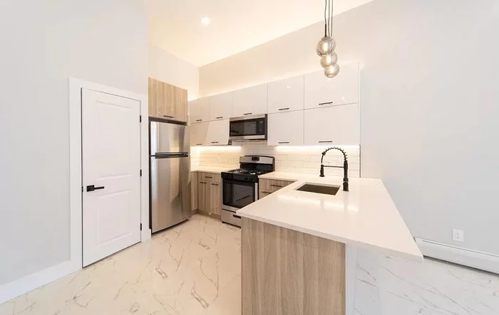 Completely renovated Single family rowhouse that gives Brooklyn brownstone vibes! Located in the fastest growing part of Jersey City in the Bergen Lafayette section. This home boasts beautiful marble floors, quartz countertops, luxe finishes and more! Dont miss this opportunity to gain equity in the fastest growing city in NJ! Open House Sat 4/20 and Sun 4/21. Call Kamila 9O8-5OO-939O with questions. Located just blocks away from the new City Hall Annex and just 4 blocks away from the light rail that can take you to different parts of the city such as Journal Square, Grove, Hoboken or even towards Newark airport for travels