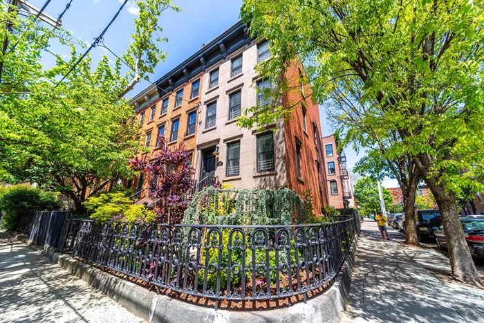 Welcome to a stunning 4-bedroom, 3.5-bathroom historic brownstone nestled in the heart of Downtown Jersey City's Harsimus Cove neighborhood! This South-facing corner residence boasts exquisite restoration, lovingly returned to its original single-family splendor from a previous 3-family configuration. As you enter through the oversized, lush front garden to the lower level, you're greeted by the radiant heated ground floor, featuring an expansive dining area, a state-of-the-art kitchen with custom cabinetry, quartz countertops, a butcher block island, and top-of-the-line appliances including a SMEG oven/range and Bosch appliances. The convenience continues with a Miele W/D, ample storage including a coat/shoe closet, and a half bath. Step out through the back door to your private fenced backyard oasis, complete with green grass, pavers, beautifully maintained landscaping, and an oversized shed for storage. The first floor welcomes you with main French doors leading to a spacious living room flooded with natural light, wire-brushed oak floors throughout, and a versatile bonus room with a full bathroom. Ascend to the second floor to discover two additional bedrooms with ample closet space, a linen closet, and another full bathroom. Finally, retreat to the top floor primary suite, drenched in sunlight from two skylights and surrounding windows. The luxurious primary bathroom features radiant floor heating, a rain shower, double sinks, and a deep soaking tub, providing a spa-like experience. This home is not only a dream inside but is also ideally situated amidst Jersey City's finest amenities, including Hamilton Park, Marin Green Park, Newark Avenue shopping, the Jersey City Waterfront, and the Grove Street PATH stop. Nearby schools include prestigious institutions such as The Scandinavian School of Jersey City, Hamilton Park Montessori, The Brunswick School, McNair Academy, Garden Preschool Cooperative, the French American School, and the Cordero School. Plus, enjoy easy access to Jersey City's elite dining and nightlife scene, with renowned establishments like Razza, Ondo, Sushi by Bou, Corto, Hudson & Co, Ani Ramen, DomoDomo, The Archer Bar, The Ashford, and Dullboy just minutes away. Notably, this home was recently featured in the new Robert De Niro and Bobby Cannavale film, Ezra. Don't miss the chance to own a piece of cinematic history and experience unparalleled luxury living in Jersey City!