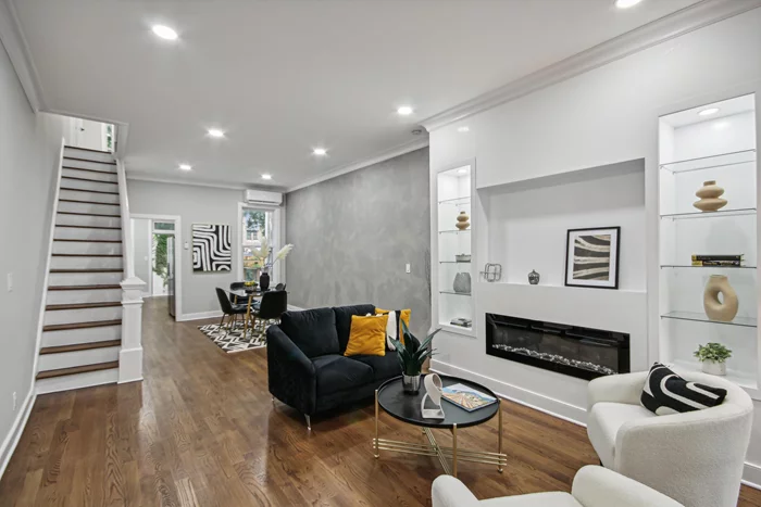 Discover the perfect blend of modern & historic charm in this gut-renovated 3-story brick row home, located on one of Jersey City's most picturesque, tree-lined blocks. Offering 1896 Sq ft of meticulously crafted living space, this residence sets a new standard for refined urban living.Step inside to a warm and inviting atmosphere where every detail has been thoughtfully considered.The 1st level is designed for entertaining! Cozy up next to the fireplace in your spacious living room, effortlessly flowing into a beautiful dining area and a gorgeous quartz kitchen outfitted with sleek Samsung appliances. This space extends to a back deck ideal for gatherings where you're surrounded by lush greenery creating a tranquil escape.Offering 3 generously sized Bedrooms & 2 bathrooms beautifully finished with Italian porcelain tiles, bathed in natural light enhancing the serene & vibrant ambiance throughout. The original staircase has been carefully restored, adding a touch of historic character that harmonizes with the home's modern updates.The fully finished basement provides a flex space w a full bath, Whirlpool washer & dryer, complete with two convenient walkouts, one leading to the street & the other to the private backyard. This adaptable area is perfect for a den, gym, or additional living space. 51 Park Street is truly a rare find, seamlessly combining historic elegance with contemporary comforts, all in a coveted location. Don't miss the chance to call this exceptional property your new home!