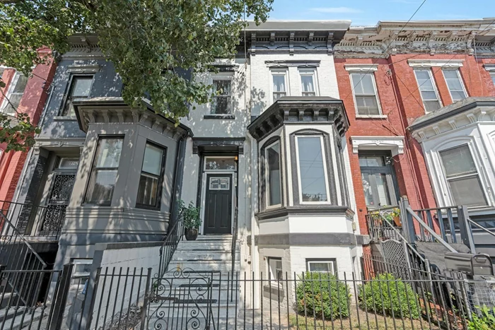 Elegant, historic, modernized 1895 Victorian row house stunner! Everything, from the beautifully maintained brick to the exterior architectural details - Bay window, decorative moulding, brackets, and dentils- beckons you within and welcomes you home. The entry foyer is a sleek marriage of old and new - lovely wide mouldings and banister topped with a Mid-Century sputnik. Gorgeous original medallion crowns the sun filled living room w its bay window, decorative marble mantle, wide mouldings and parquette floors that continue into the 6 person private dining room that also has a marble mantle. The bright white modern eat in kitchen, is newly renovated and has tons of storage. A small deck leads down to the back garden. This is truly an urban oasis, a gardener's delight, a barbecue pit master's paradise. Stone pavers keep the garden clean and create a perfect local for outdoor dining and relaxing. Back inside, upstairs boasts 3 bedrooms and a second full bath. Typically Victorian, there are some quirky details like the L shaped primary bedroom that comfortably houses a king-sized sleeping area. There are two additional marble mantles in the bedrooms. The basement is fully renovated and has enough space that it currently accommodates a family room, a bar, a laundry zone and lots of storage. This MUST SEE is not just a house, it's a home.