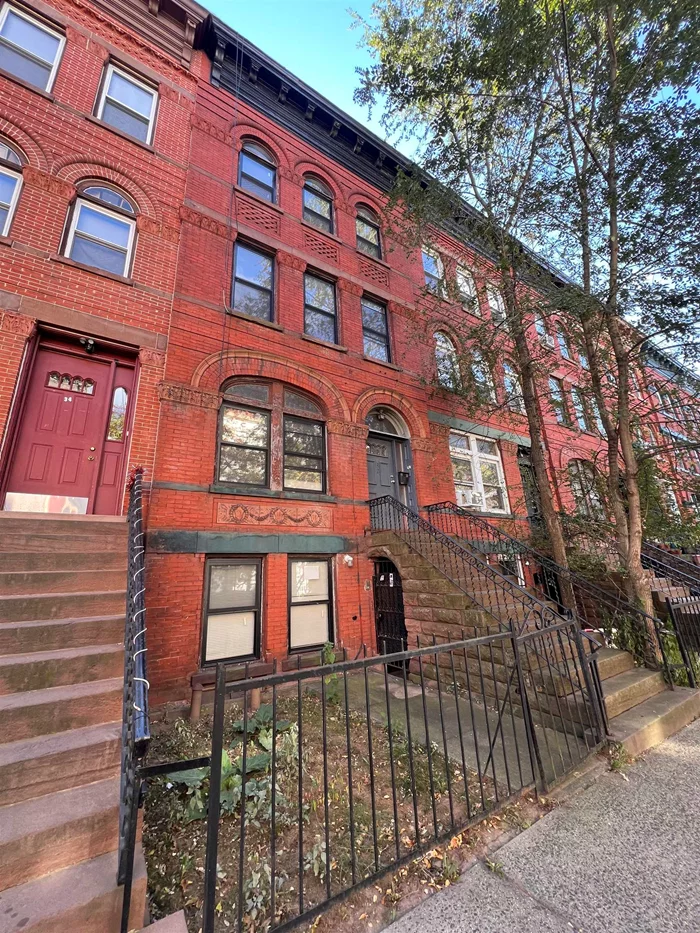 Welcome to 32 Monticello Avenue in Jersey City, NJ. This is a four level Brownstone with so much space, you'll be amazed. On the ground floor, you will find two bedrooms, each with it'svery own brand new bathroom. This level also allows you to exit to the front of the house at street level or to enter the beautiful, fenced-in rear yard. On the main level is where you will find the open concept Kitchen, Living and Dining Room, plus a new half bath. Upon entering the third level is where you will find one bedroom with a walk-in closet, a new full bathroom and another room that can be used as a bedroom, or, this entire level can serve as a primary suite. When you reach the top floor, you will love the large open space that can be used for anything your heart desires, a laundry closet, another brand new full bathroom and one more bedroom with large closets. This entire level can also be used as a primarysuite. The possibilities are truly endless here. Please note that this was a renovation project in process (new plumbing, heating, electricity, walls, floors, fixtures and doors), but there are still a few things left tobe done, such as installing kitchencabinetry and appliances, carpentry and finishing touches throughout, and some sheetrock repairs due to prior water damage. In addition to the size of this beautiful Brownstone, you will love the central air, multiple exposed brick walls, fireplace mantles, pocket doors and skylights. Make your appointment today, because tomorrow could mean sold.