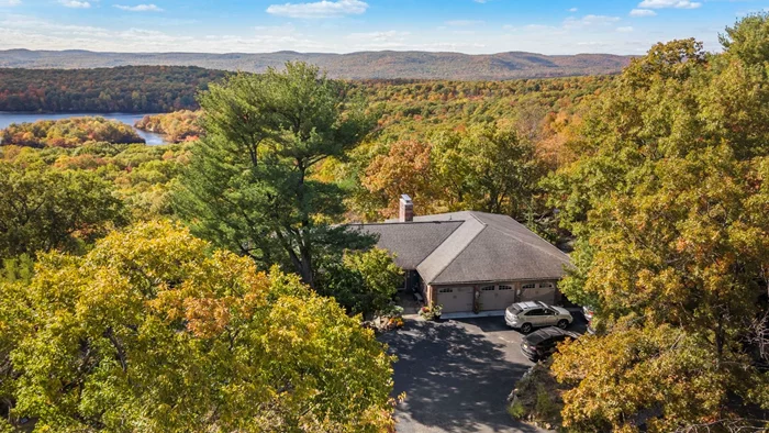 A ONE OF A KIND, OUT OF THIS WORLD, SPECTACULAR setting you have to truly see and experience to believe. Perched high atop the Ramapo mountains this exquisite home, set on 5 private acres, is one that will TRULY take your breath away. With five bedrooms and 3.5 bathrooms the home ebbs and flows with life's many exciting changes. Live entirely on one floor or effortlessly expand to both securing a perfect living situation for extended family, aging inhabitants, caretakers and staff alike. Panoramic views from every room envelop you in the beauty of nature and sunset views grasp your heart and refuse let go. With an inground pool, plenty of room for gardening/homesteading, walk out living level onto covered patio and massive expansive upper deck, the outdoors can be appreciated from all angles. Enjoy the stunning vistas as you read a book in the library, get cozy in bed in the primary suite, host a holiday dinner in the formal dining room and cocktail parties on the grounds. Grab a bottle of wine in the wine cellar and enjoy the sun setting over the unobstructed views of the Ramapo mountains and lake. Go for a walk throughout the 360 degree surrounding state forest/park after a long day. The possibilities are quite literally, endless! With highly ranked schools and NYC transportation just a drive down the mountain you truly have found an incredibly unique home and one that is sure to stun for generations to come. Don't miss this once in a lifetime real estate opportunity!