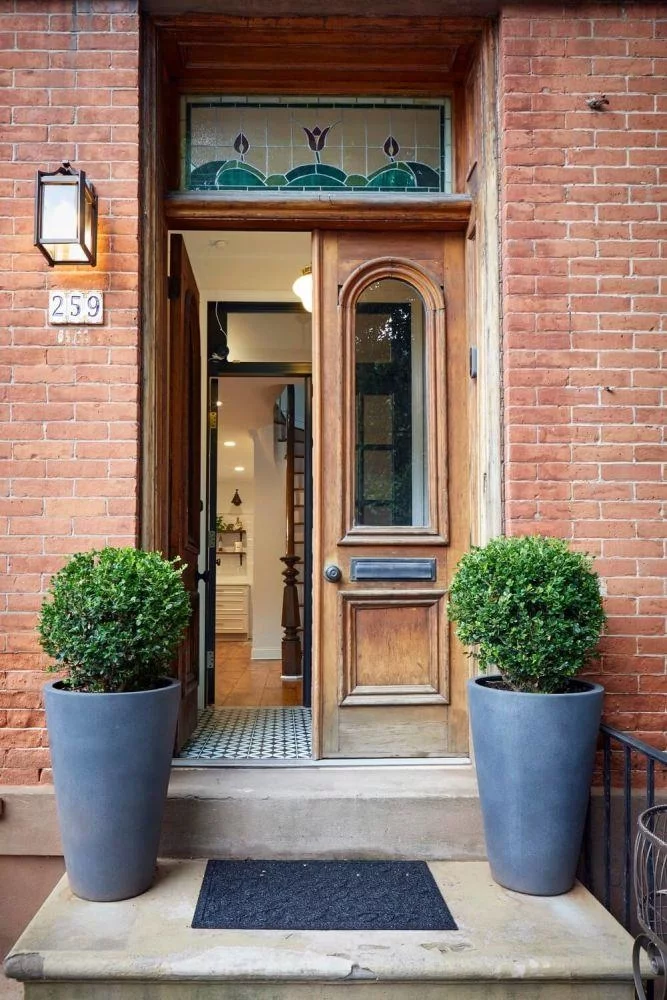 Welcome to 259 2nd Street, a historic 1864 brick row townhouse nestled in the charming Harsimus Cove neighborhood of Downtown Jersey City. Just three blocks from the Grove St PATH, this home is the perfect blend of original detail and modern convenience. Step inside to discover a bright and open layout spanning over 2100 sq feet with high ceilings on every floor. The first floor has been meticulously renovated, featuring a brand new kitchen with granite countertops, stainless steel appliances, and a windowed design that invites natural light. The open kitchen flows seamlessly into the living area, where exposed brick and a cozy fireplace create a warm and inviting atmosphere. A newly added powder room and a private patio, perfect for outdoor entertaining, complete this level. This townhouse gem is adorned with crown mouldings and hardwood floors, enhancing its timeless appeal. Boasting three bedrooms, including a primary suite with an ensuite bathroom with skylight and a walk-in closet. The family room, which can easily be converted into a fourth bedroom, offers flexibility to suit your needs. With 2.5 bathrooms, including beautifully renovated spaces, comfort and convenience are at the forefront. Additional features include central air and a partially finished basement with ample storage space. Not to be missed are the crown mouldings and hardwood floors, which enhancies its timeless appeal. With a variety of schools/ pre-schools, public (PS-5) and private (FAA/Scandi), the vibrant arts, restaurants, shopping and nightlife, this is truly a great place to call home!