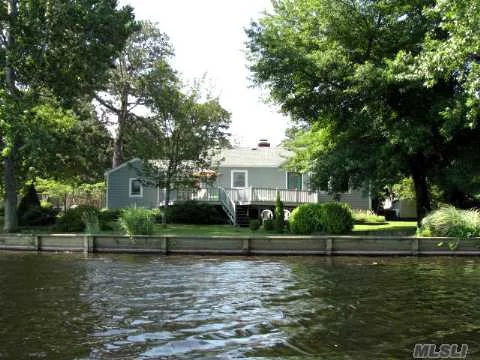 Location, Location! Beautiful Waterfront 2Br Home On 2 Bulkheaded Lots W/Panoramic Views Of Peconic River! Lr W/Brick Fplc, Updated Kit W/Ss Applncs, Dining Area, French Doors, Laundry Room, Hw Flrs, Breezeway To 1.5 Car Gar, New: Roof, Cedar Siding, And Heating Sys, Large Deck Overlooking The Peconic; Canoe, Fish, And Kayak Right From Your Backyard, Must See!