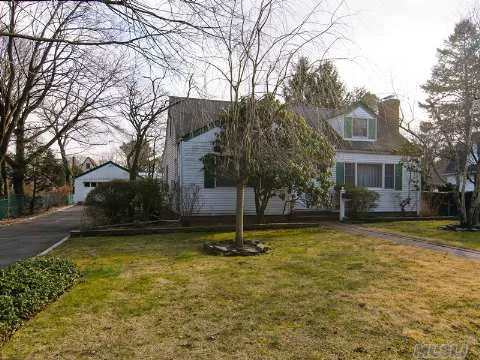 Fabulous Location In North Syosset! Lovely 4 Bedroom, 2 Full Bath Cape Home Set On Large Deep Private Property. Sunny Living Room With Fireplace, Hardwood Floors Thoughout Entire Home.