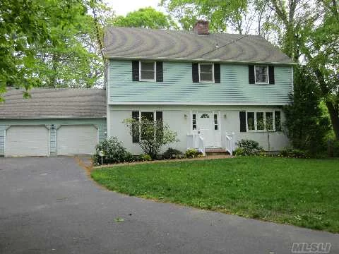 N Of N Country In Woodland Acres Sits This Light & Bright 4Br, 2.5 Bth Colonial W/Gleaming Hw Flrs, Flr W/Brick Fplc, Built-Ins, Lots Of Closets, Some New Doors & Light Fixtures, New Carpet, Freshly Painted, Alarm, Whole House Generator, Full Bsmt, Newer Roof, 2 Car Gar, All On Pvt .50/Ac W/18X36 Deck, Swrsd, Must See! Peconic Tax Applies, Taxes Being Grieved