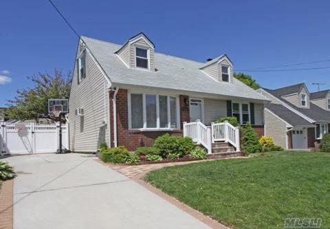 Outstanding Wide-Line Cape. Rear Dormered, Desirable Carle Place School District, New Vinyl Siding, New Windows, Two New Bathrooms, New Driveway. Beautiful Landscaping. Dead End Street, Close To Mineola Pool And Park.