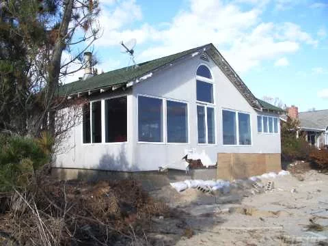 Bayfront Cottage. Panoramic Views With Sandy Beach. Great Room With Fireplace, Eat In Kitchen, Dining Area, Master Bedroom With Master Bath And Additional 2 Bedrooms And Bath. Detached 2 Car Garage, Deck And Dock Rights. Needs Tlc Best Buy