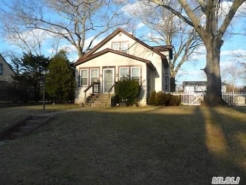 Classic Colonial In Brightwaters Features Enclosed Porch, Fireplace & Hardwood Floors On Large Parklike Grounds. Taxes W/Star 9, 439.00. 1 Year Home Warranty Included