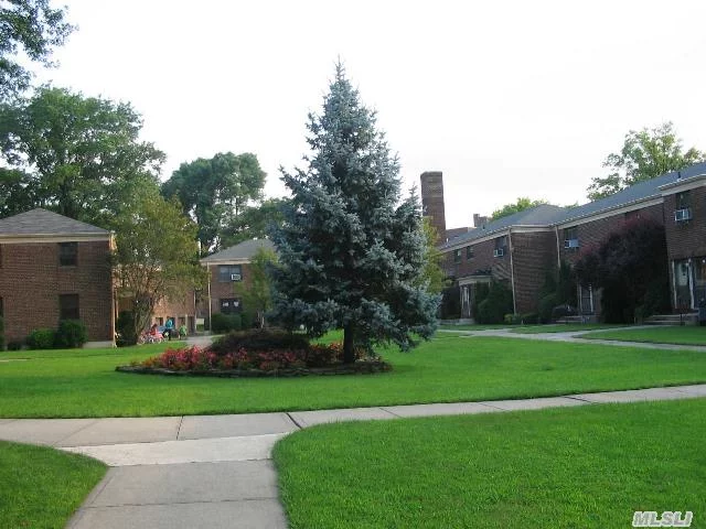 Perfect Location.Semi-Det. Corner Unit With Triple Exp.Set-Back In A Quiet Landscaped Courtyard.Updated Kitchen And Bath. Private Entrance School Dist#26 24 Hrs.Security.2 Parking Spaces Incl.Maint.Tax.Heat, Gas, Water Incl. Expr.Bus To Manhattan. Nearby Shops.No Flip Tax.