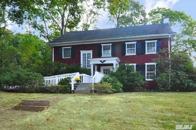 Magnificent Center Hall Colonial. 4 Bedrooms, 3 Baths, Just .6 Mile To Lirr. 18X25 Great Room W. Fp & Built-Ins, Living Room W. Fp, Formal Dr, Eat-In Kitchen W. New Appliances, Leading To Wrap Around Deck, Overlooking Park-Like Property. Beach, Mooring , Tennis Available W. Fee.