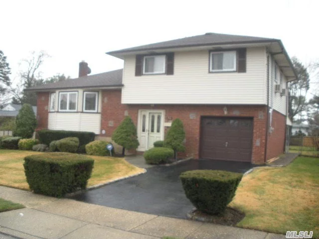 Lovely, Clean,  Large Wide Line Split With Updated Roof, Windows And Vinyl Siding. Newer Cabinets And Granite Countertops In The Large Eik.  Wood Floors Under Carpets; Igs, Mbr Suite With Full Bath, Belgium Block Sides On Driveway 150 Amp Electric, Weil Mclean Burner,  Large Backyard; Great House For Entertaining, And It Is The Best Priced Split In Plainview Sd 21!