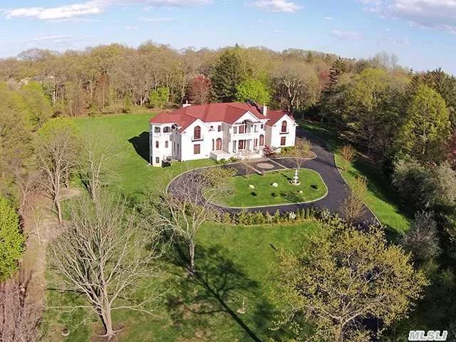 Stunning Brick Colonial Set Behind Private Gated Driveway On 3 Acres Of Flat, Landscaped Property. The Residence Boasts All The Amenities Of Luxury Living With 8 Bedrooms Including 3 Master Suites W/ Jacuzzi Tub, Solar Heat For All Water & Radiant Heat On 1st Floor & All Baths. Finishedlower Level With Lap Pool, Sauna & Gym.