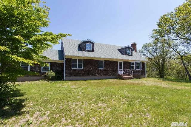 Classic North Fork Cape On Private Road Just Off Coveted Peconic Bay Blvd. The 2400 Sq Ft Home Boasts 4 Large Bedrooms And 3+ Full Baths, 2 Car Garage With Egress To The Full Basement. The Master Is On The First Floor. Ample Closets And Storage Throughout. Easy Walk Or Bike Ride To The Great Peconic Bay.