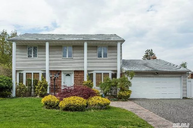 Beautiful Center Hall Colonial In Woodbury Knolls. Great Location! This 4 Bedroom 2.5 Bth Home Features Flr, Fdr W/ Molding Detail, Large Family Rm W/Fireplace, Hardwood Floors,  Updated Eik, W/ Wood Cabinets, Granite And Stainless Steel Appliances, Finished Bsmt, Plenty Of Storage, 2 Car Garage, Syosset Sd.