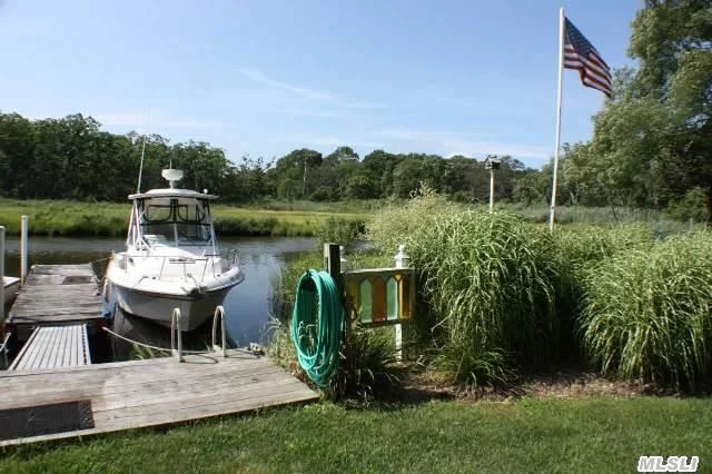 Protected Views Are Yours At This Waterfront Coastal Living Cottage In A No Flood Zone. 2 Bedroom, 1 Bath, L/R W/Wood Burning Brick Fireplace, Eik. Newly Staged. Floating Dock On East Creek W/Water &Electric Fits 26 Ft. Boat Direct Access To Peconic Bay. In-Ground Sprinklers, 1 Car Attached Garage & Full Set Of Plans For Expansion With Sale. Close To Beach, Vineyards, Town.
