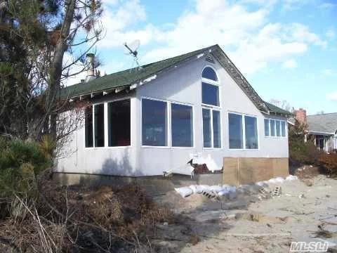 Bayfront Cottage With Panoramic Views. Sandy Bay Beach. Great Room With Fireplace, Dining Area, Kitchen, Laundry Room, 1/2 Bath, Master Bedroom With Bath. Additional 2 Bedrooms And Bath, Deck And 2 Car Garage.Permits For Bulkhead Great Potential Boat Slip